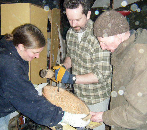 Jessica and Loughie help Stephen with the gouging of the hull.